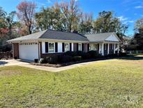 Brick ranch home with attached garage and spacious yard at 5486 Kershaw Camden Hwy, Heath Springs, SC 29058