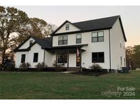 Two-story farmhouse style home with white siding and black trim at 4308 29Th Street Ne Dr, Hickory, NC 28601