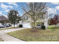 Two-story house with attached garage and landscaping at 9702 Eagle Feathers Dr, Charlotte, NC 28214