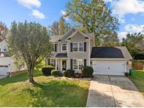 Two-story house with gray siding, attached garage, and landscaping at 4721 Buckminister Ct, Charlotte, NC 28269