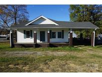 Charming one-story house with a covered porch and well-maintained lawn at 7318 Old Mt Holly Rd, Charlotte, NC 28214