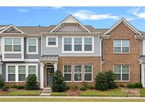 Brick and gray siding townhome with landscaping and a front door at 208 Waterlynn Ridge Rd # B, Mooresville, NC 28117