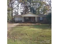 Brick ranch home with a covered porch and a spacious yard at 441 Holly Cir, Mount Holly, NC 28120