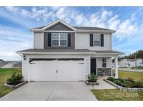 Two-story house with a gray and white exterior, a two-car garage, and well-maintained landscaping at 1226 Phifer Rd, Kings Mountain, NC 28086
