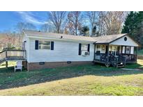 Single story home with front porch, deck and large yard at 940 Devil Track Rd, Taylorsville, NC 28681