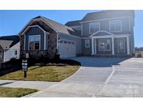 Two-story home with stone accents and a three-car garage at 2068 Fordhill St, Rock Hill, SC 29372