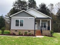 Gray sided home with brick base and a front porch at 3010 Forbes Rd, Gastonia, NC 28056