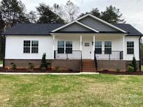 Craftsman style home with gray and white exterior, front porch, and landscaped yard at 3008 Forbes Rd, Gastonia, NC 28056