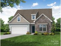 New construction home with stone and shingle accents, two-car garage, and landscaped yard at 4025 Grace Pointe Dr # 105, Wesley Chapel, NC 28079