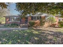 Brick ranch home with a covered entryway and landscaping at 1138 Laurel St, Salisbury, NC 28144