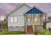 Charming craftsman style home with a blue accented gable and brick steps at 1105 Kenly St, Salisbury, NC 28144