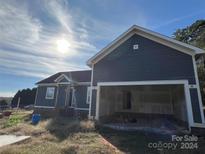 Newly built home with gray siding and attached garage at 1517 Sugarfarm Rd, Catawba, NC 28609