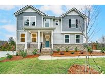 Two-story home with gray siding, stone accents, and a teal front door at 14415 Autumncrest Rd # 2, Huntersville, NC 28078