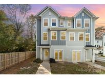 Three-story townhome with gray siding and a charming front porch at 2304 Via Dei Conte Aly, Charlotte, NC 28205