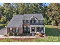 Two story brick house with front porch at 2559 Cypress Oak Ln, Gastonia, NC 28056