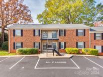 Brick building exterior with parking and landscaping at 5903 Quail Hollow Rd # D, Charlotte, NC 28210