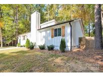 White house exterior with wood accents, landscaping, and a large yard at 11116 Vista Canyon Dr, Charlotte, NC 28226