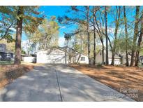 Attractive house exterior with a driveway and landscaping at 6920 Stillmeadow Dr, Charlotte, NC 28277