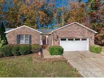 Brick ranch house with attached garage and landscaped yard at 1335 Huckleberry Dr, Lincolnton, NC 28092