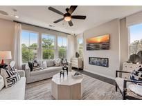 Spacious living room with fireplace, large windows, and comfortable seating at 357 Jetton St, Davidson, NC 28036