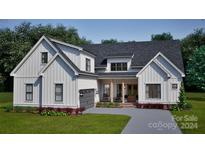 Two-story farmhouse with white siding, gray garage door, and a covered porch at 119 Ll Harwell Rd, Gastonia, NC 28056