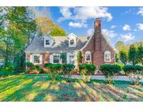 Brick home with landscaped lawn and walkway at 3703 Margaret Wallace Rd, Matthews, NC 28105