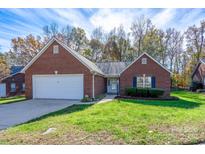 Brick ranch home with attached garage and landscaped yard at 103 Prestwick Ct, Salisbury, NC 28146