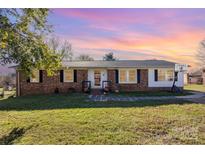 Brick ranch home with landscaped lawn, basketball goal, and walkway at 319 Circleview Dr, Shelby, NC 28150