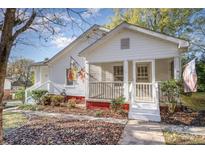 White house with front porch and landscaping at 579 Gibson Nw St, Concord, NC 28025