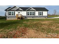 Gray and white single story home with a deck and large yard at 51 Rosemont Dr, Stony Point, NC 28678