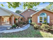 Brick ranch house with landscaped yard, covered carport, and walkway at 1811 Charter Dr, Rock Hill, SC 29732