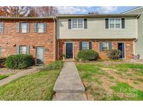 Brick townhouse exterior with landscaping and walkway at 3109 Heathstead Pl, Charlotte, NC 28210