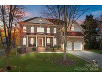 Brick two-story house with a red roof and a large front yard at 157 Montibello Dr, Mooresville, NC 28117