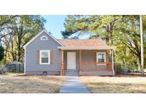 Gray house with wood accents, landscaping, and a walkway at 403 N Ransom St, Gastonia, NC 28052