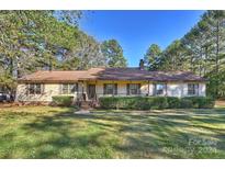 Ranch style house with mature trees and a spacious lawn at 608 Raintree Dr # 19A, Matthews, NC 28104