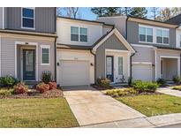 Two-story townhouses with attached garages and landscaped yards at 9232 Widden Way, Charlotte, NC 28269