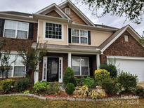 Two-story brick home with landscaped front yard at 1302 Gambel Nw Dr, Concord, NC 28027