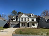 Two story home with gray siding, stone accents, and a 2-car garage at 2015 Cedar Falls Dr # 72, Waxhaw, NC 28173