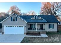 House exterior featuring a two-car garage and a brick porch at 202 E 27Th E St, Kannapolis, NC 28083