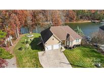 Aerial view of lakeside home with two-car garage and spacious yard at 226 Hermance Ln, Mooresville, NC 28117