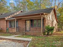 Brick ranch home with a covered porch and landscaped yard at 124 Ashleigh Ct, Fort Mill, SC 29715