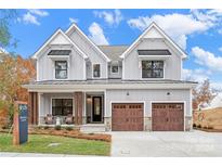 Two story home with gray siding, brown doors, and a landscaped front yard at Lot 41 Watercourse Way # Savanh, Belmont, NC 28012
