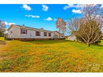 Single-wide manufactured home on a spacious lot with a deck at 227 Grassy Meadow Ln, Statesville, NC 28625