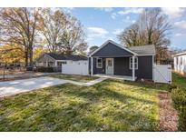 Newly built home with dark gray siding, white trim, and a grassy yard at 429 Dare Dr, Charlotte, NC 28206