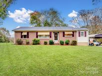 Brick ranch house with carport and landscaped lawn at 4356 Charles Raper Jonas Hwy, Alexis, NC 28006