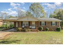 Brick ranch house with carport and well-maintained lawn at 1314 Frederick St, Shelby, NC 28150