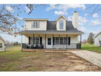 Two-story house with a front porch and driveway at 1324 Eagles Landing Dr, Charlotte, NC 28214