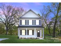 Two-story house with white siding, black shutters, and a front porch at 934 Log Cabin Dr, Gastonia, NC 28054