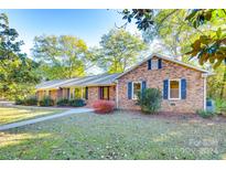 Brick ranch house with mature landscaping and a spacious front yard at 2129 James Ct, Rock Hill, SC 29732