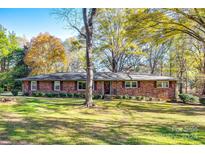 Brick ranch house with a spacious lawn and mature trees at 3808 Pine Cove Dr, Gastonia, NC 28056